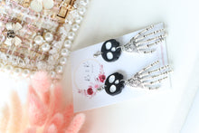 Load image into Gallery viewer, Tiny Skull Head & Steel Skeletal Hand Dangle Earrings – Handmade Gothic Halloween Jewelry | Polymer Clay Skull Earrings | KeandKi Designs
