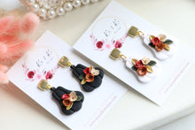 Load image into Gallery viewer, Pumpkin Floral Polymer Clay Earrings – Handmade Autumn Halloween Earrings | Fall Floral Jewelry | KeandKi Designs ( Tri color Black Red teracotta and beige Floral )
