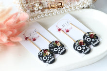 Load image into Gallery viewer, Embossed Skull Floral Dangle Polymer Clay Earrings – Handmade Gothic Floral Earrings | Spooky Elegant Halloween Jewelry | KeandKi Designs
