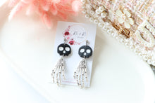 Load image into Gallery viewer, Tiny Skull Head &amp; Steel Skeletal Hand Dangle Earrings – Handmade Gothic Halloween Jewelry | Polymer Clay Skull Earrings | KeandKi Designs
